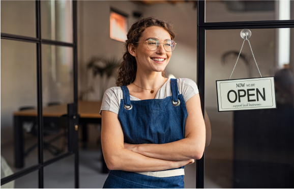 business owner in front of an open sign